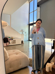 Person taking a mirror selfie in a modern living room.